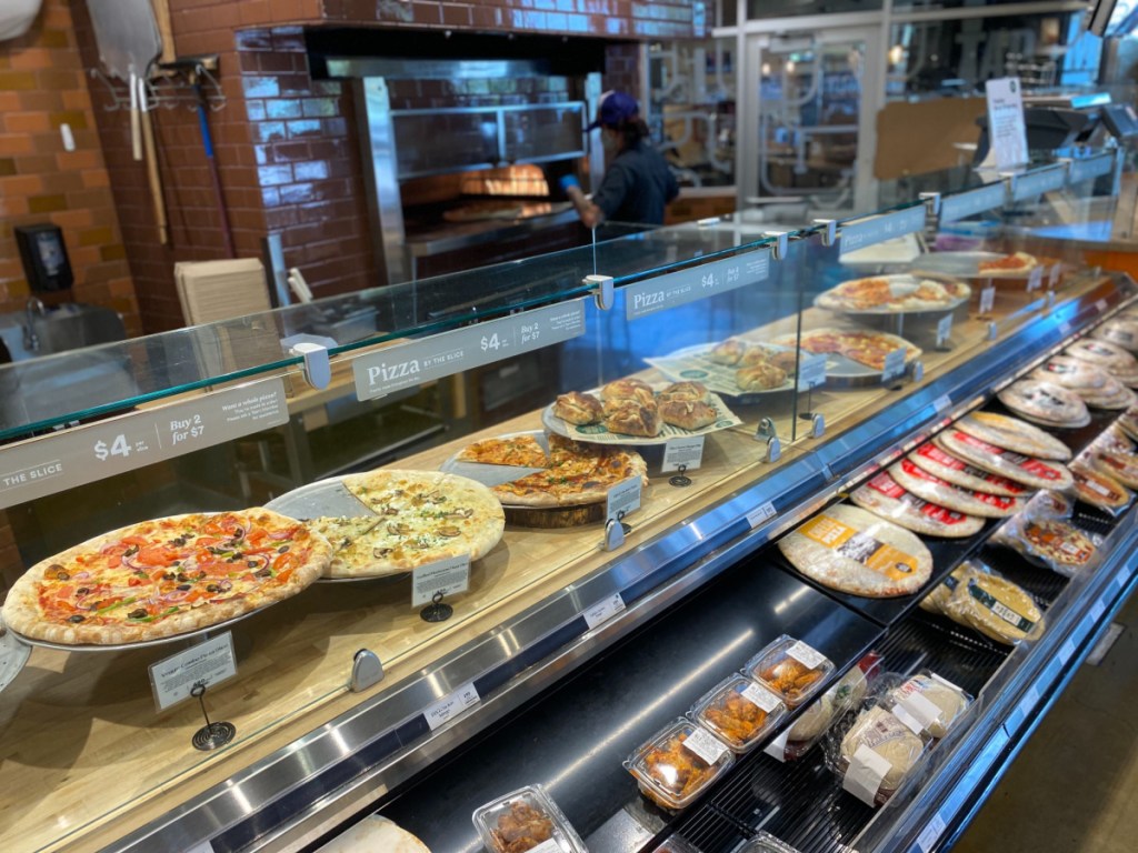 restaurant counter with pizzas on it