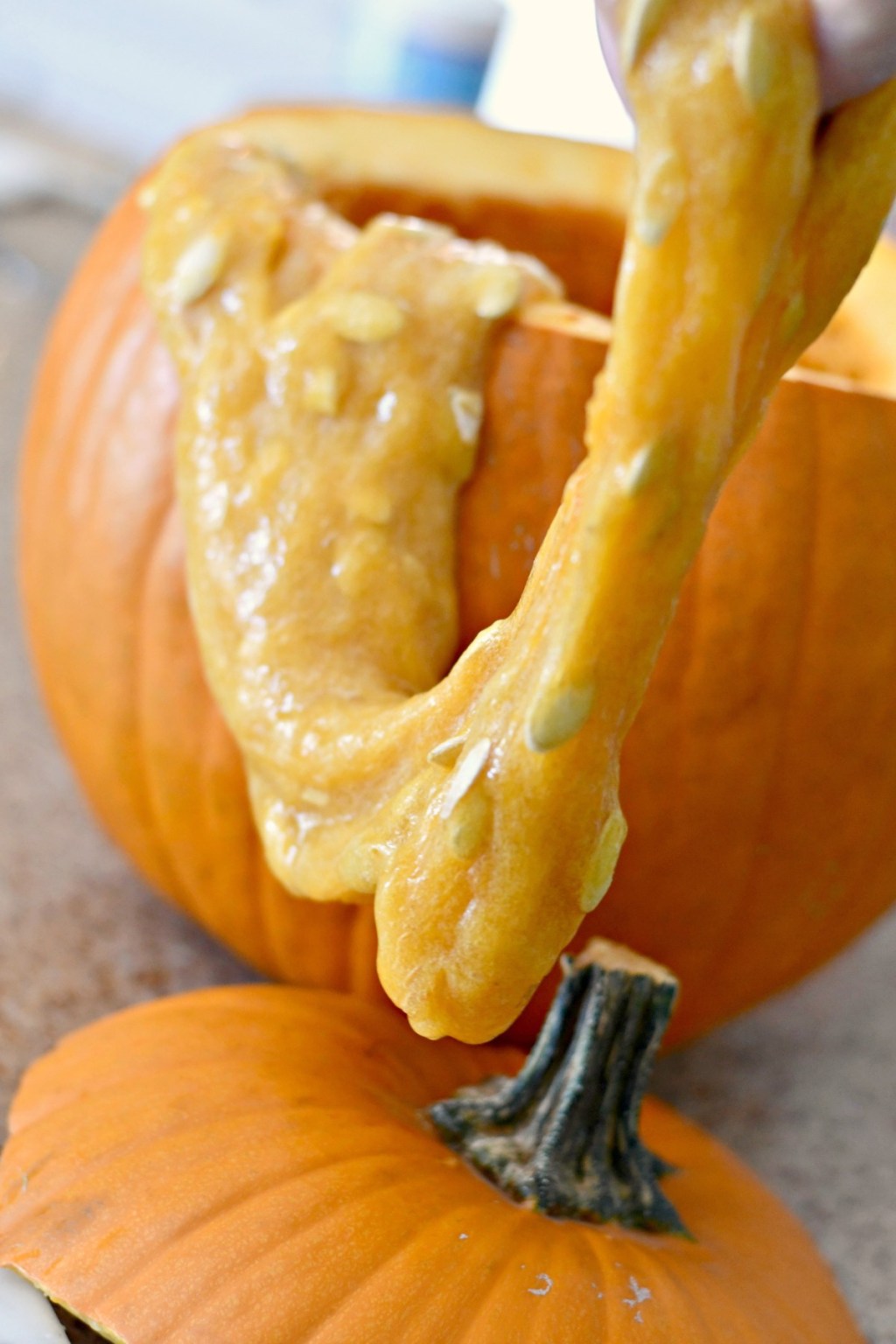 pulling slime from cut pumpkin