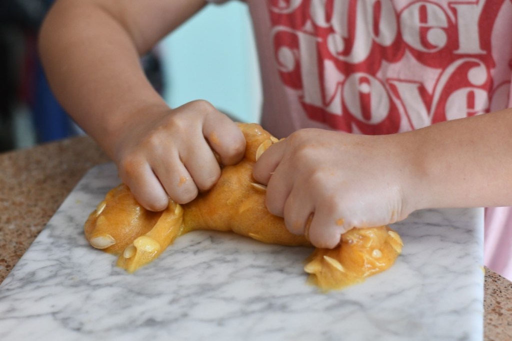 squeezing pumpkin guts slime on cutting board