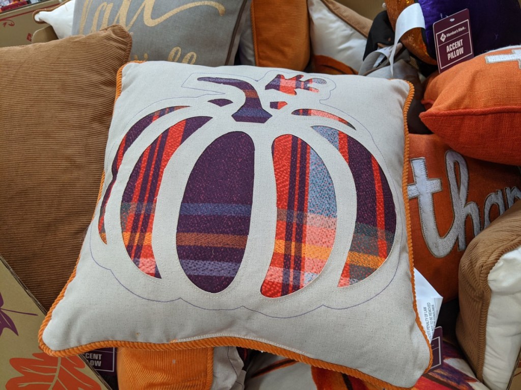 off white pillow with a pumpkin printed on it