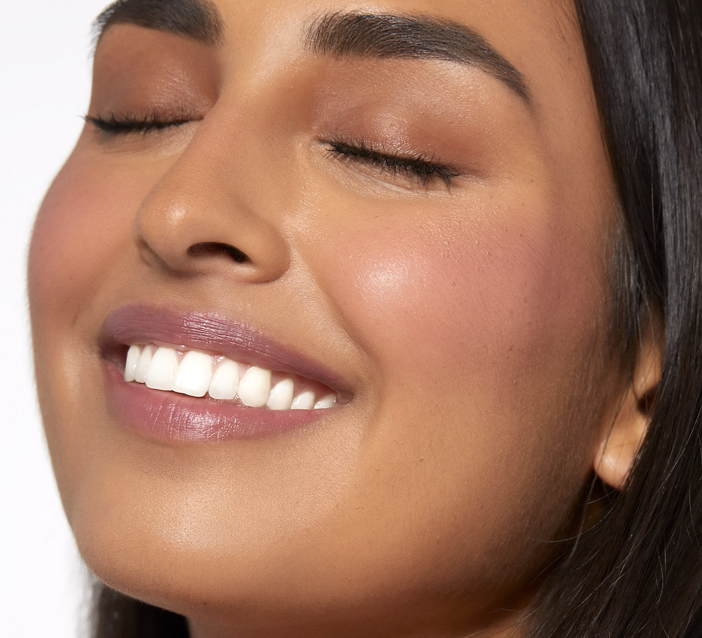 woman wearing Rare Beauty liquid blush 