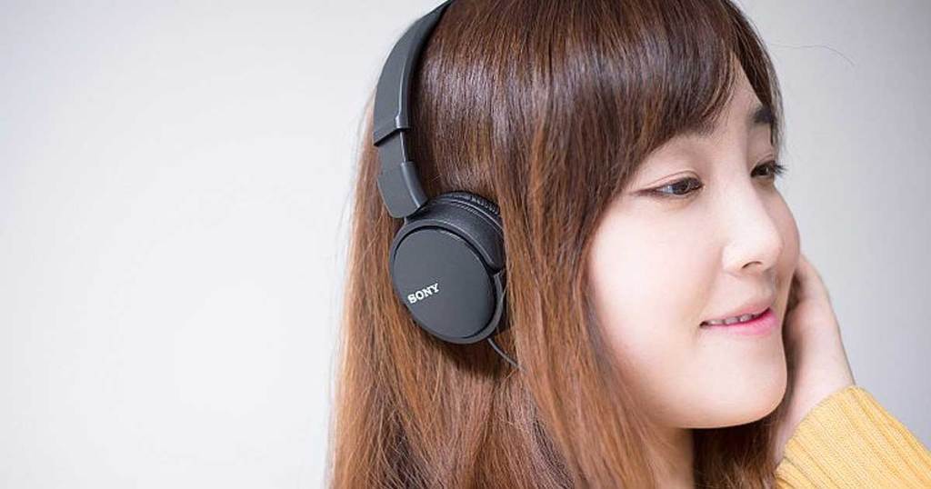 name brand headphones on woman