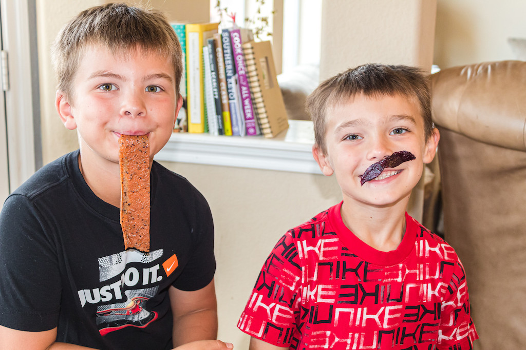 two boys being goofy with fruit rolls up