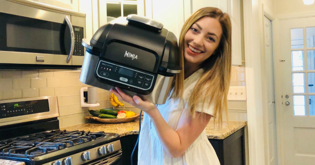 woman holding Ninja foodi indoor grill