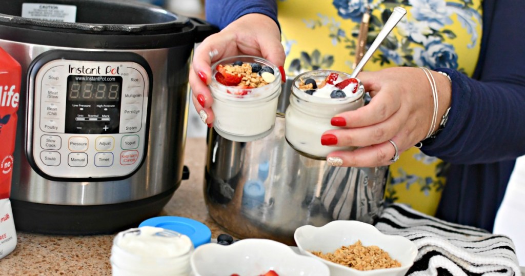 woman holding jars of instant pot yogurt