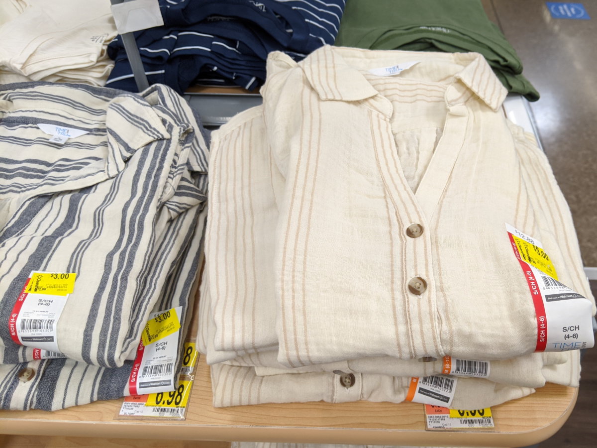 table at store with women's shirts on it