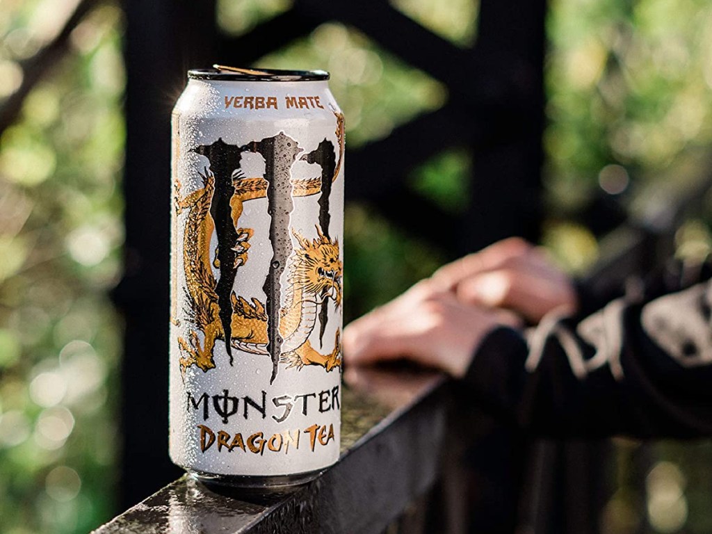 hands on balcony next to can of tea