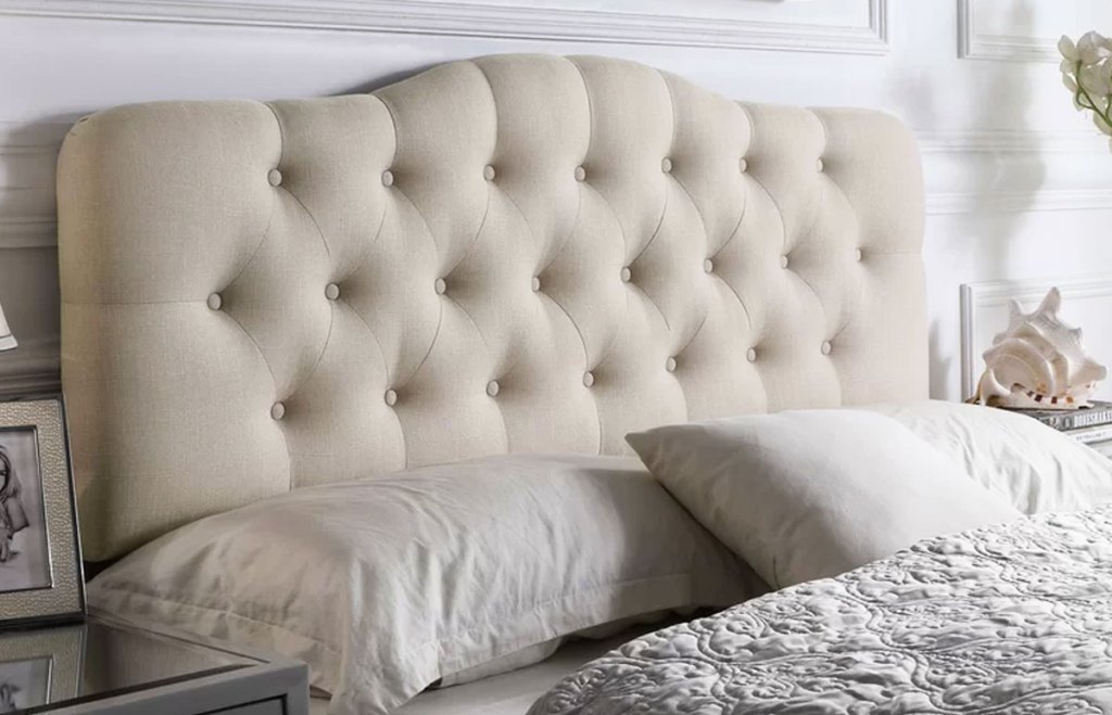 cream colored tuffed upholstered headboard