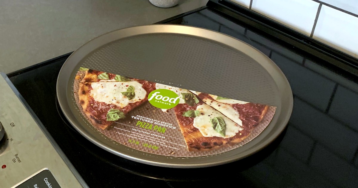 Bronze colored pizza pan on an electric stove-top