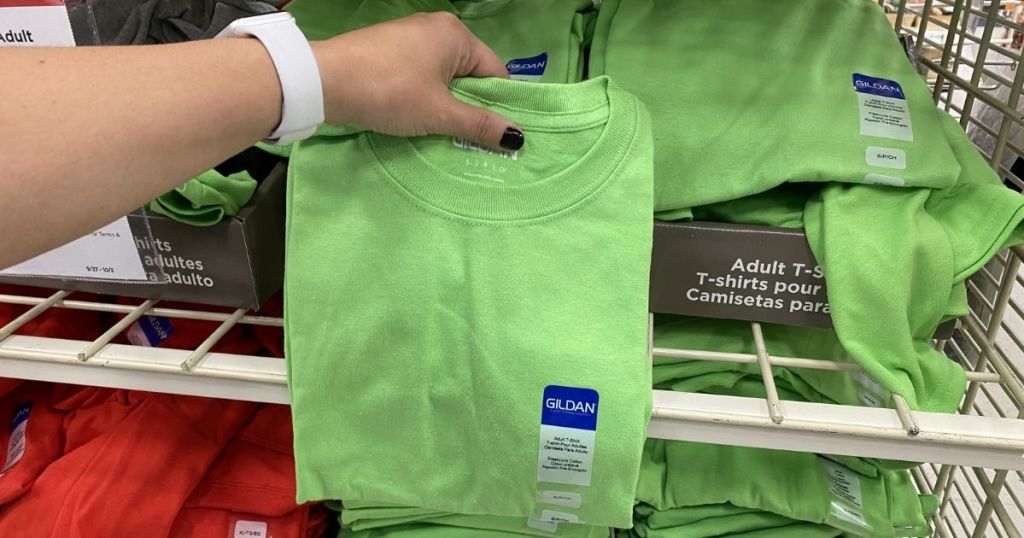 woman hand holding lime green gildan shirt in michaels