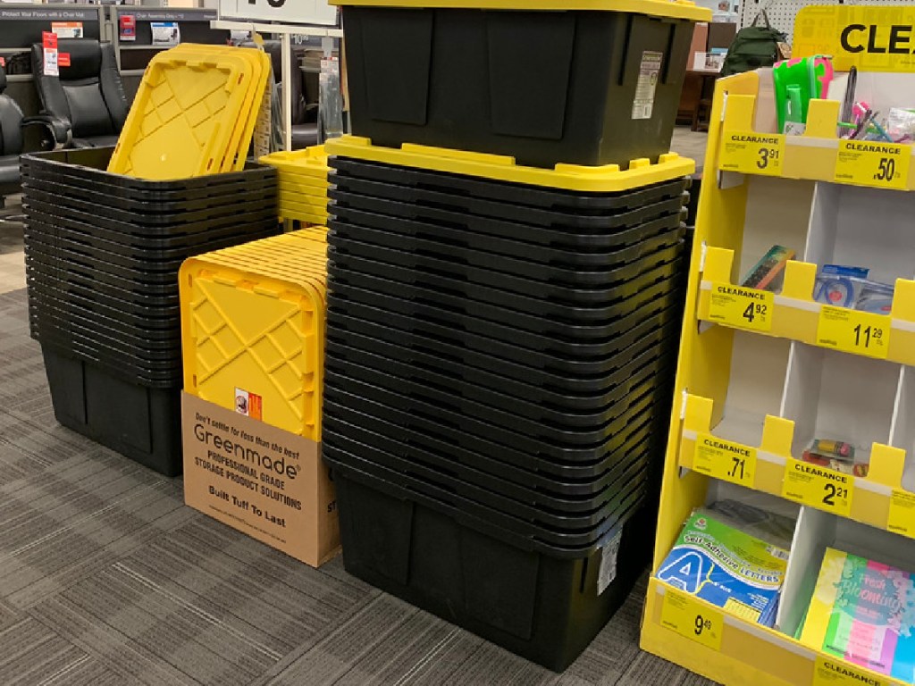 large black and yellow storage totes stacked in store