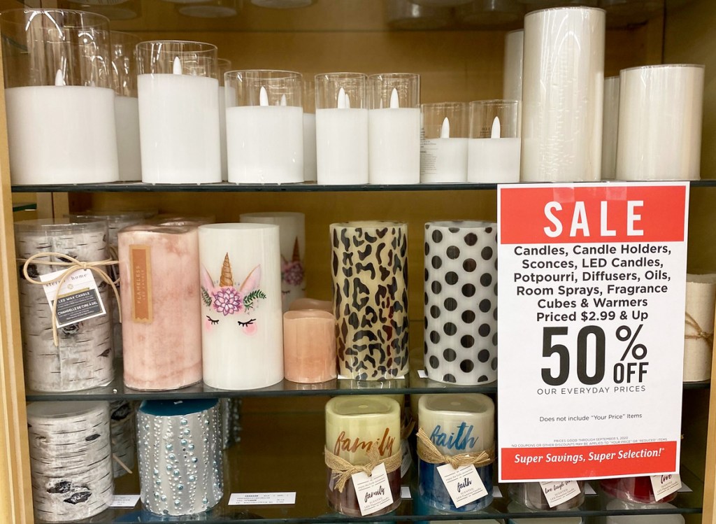 glass shelves of various colors and prints of LED candles at Hobby Lobby