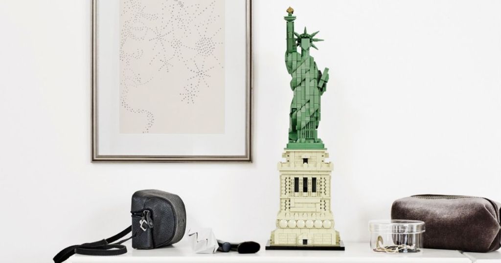 LEGO Statue of Liberty on table by camera bag