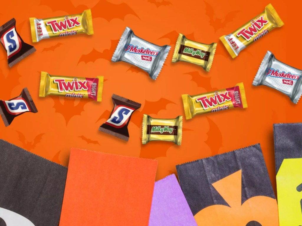 Small Mars individual Halloween candies next to Halloween p[aper bags