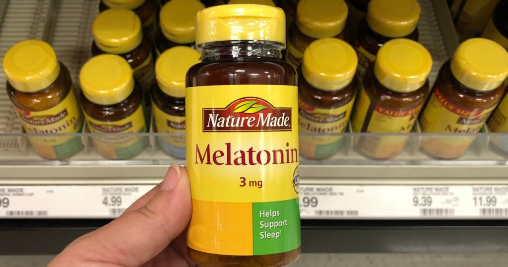 hand holding a bottle of nature made melatonin in store