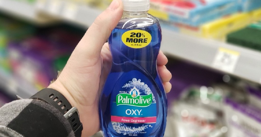 hand holding bottle of blue dish soap in store