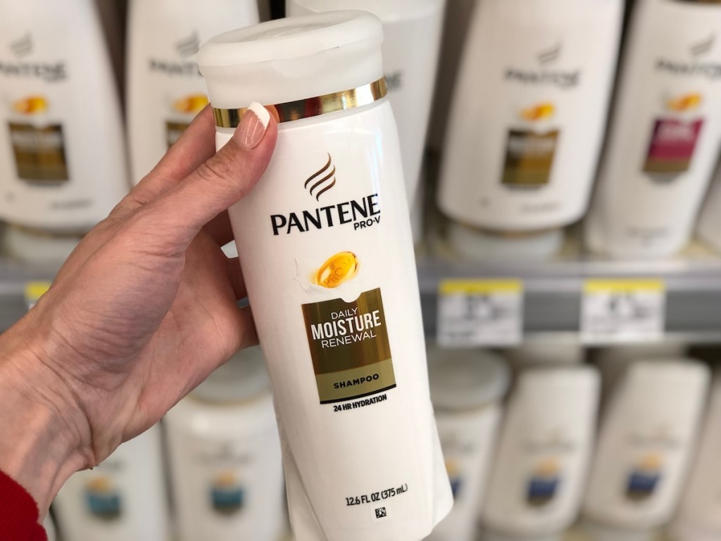 hand holding a bottle of Pantene shampoo