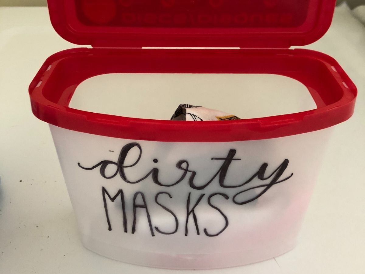 container storing reusable masks with "dirty masks" lettering 