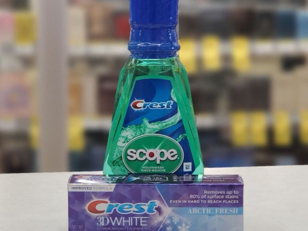 bottle of scope and box containing crest toothpaste