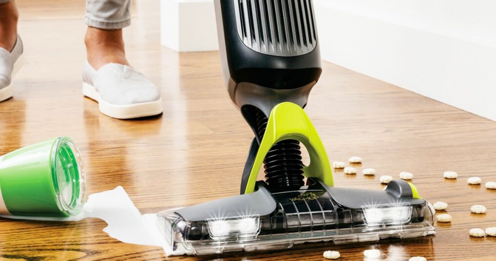 person using a shark vacmop on hardwood floors to clean up spilled milk and cereal