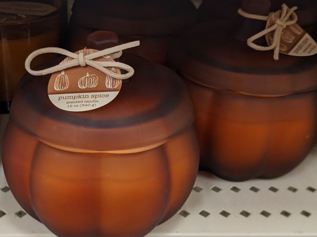 Pumpkin shaped candle in frosted glass jar