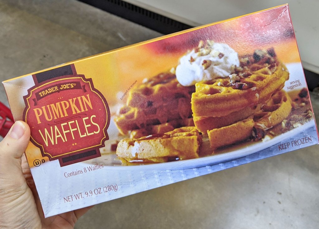 person holding up a box of frozen pumpkin waffles