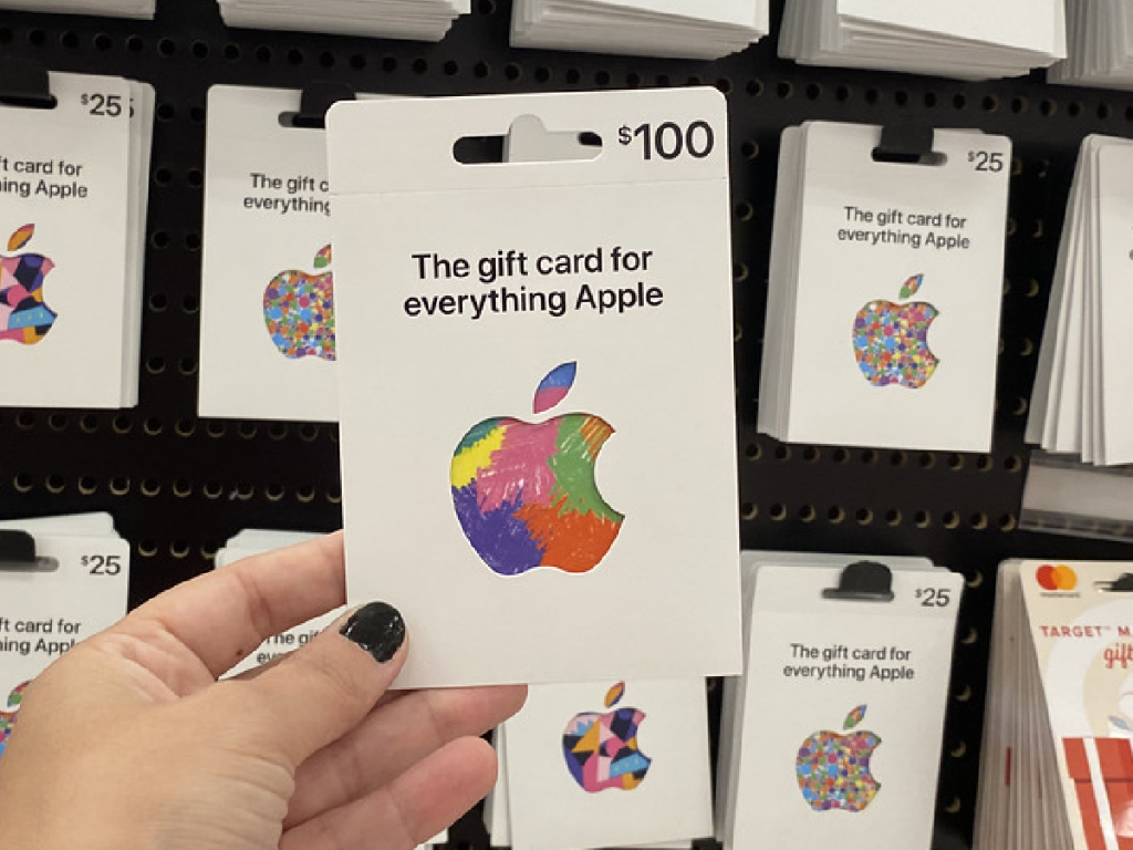 hand holding gift card by store display