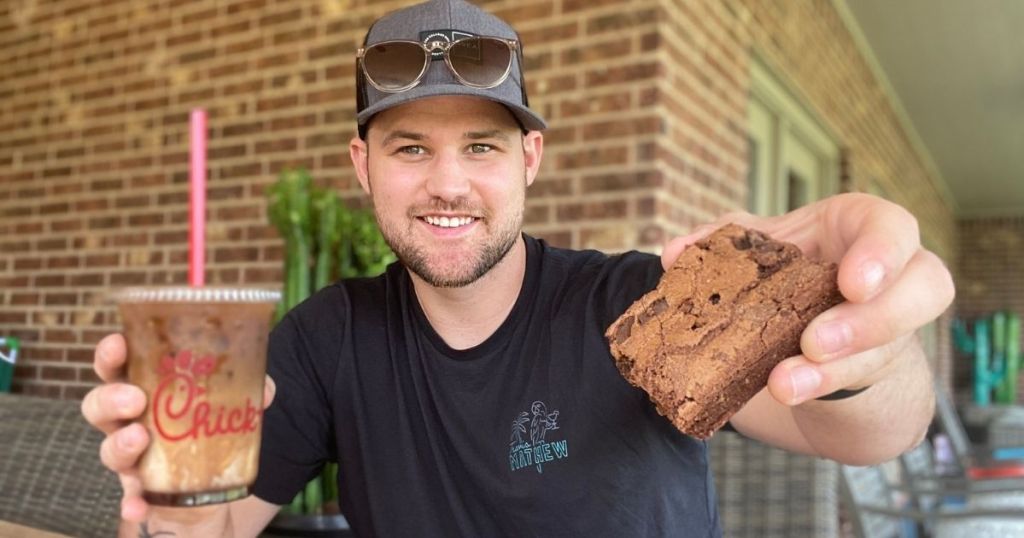 man holding Chick-fil-A shake and brownie