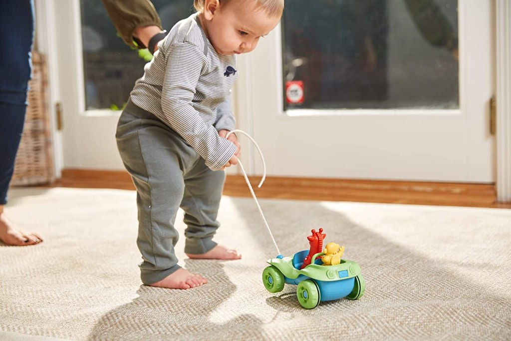 toddler boy pulling toy