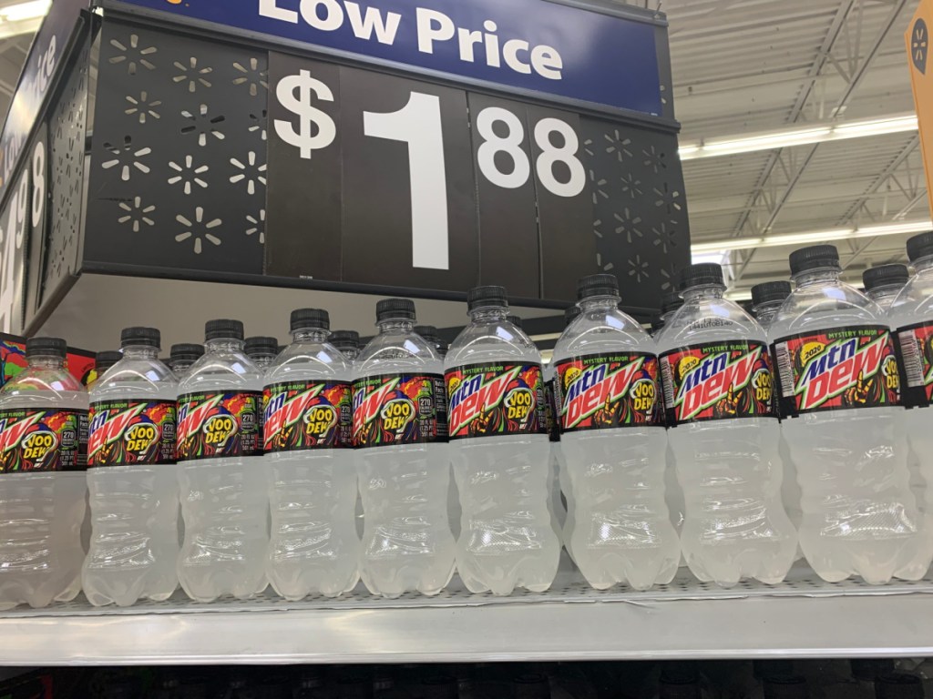 store price sign with bottles of soda under it