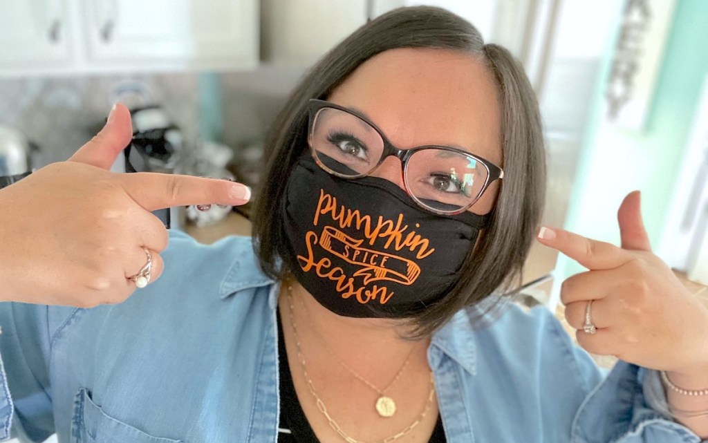 woman wearing black pumpkin spice mask