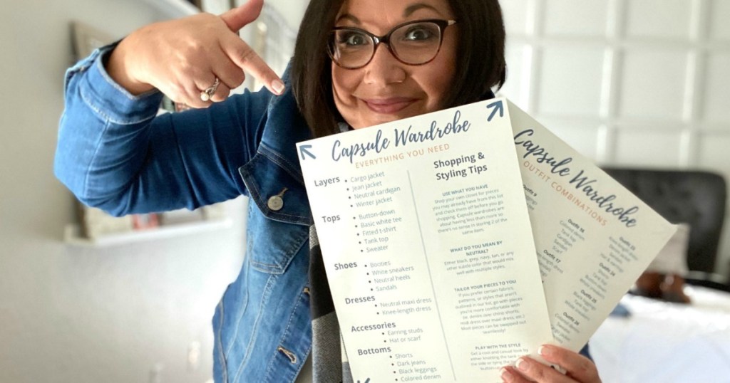 woman holding capsule wardrobe printable in hand