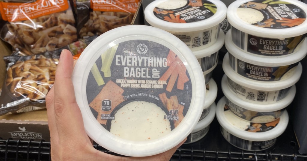 hand holding tub of everything bag dip in store