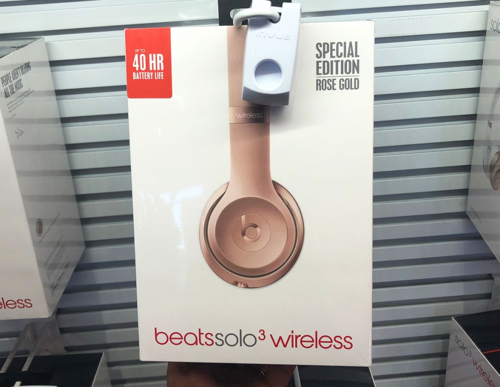 pair of rose gold beats solo3 headphones on store display