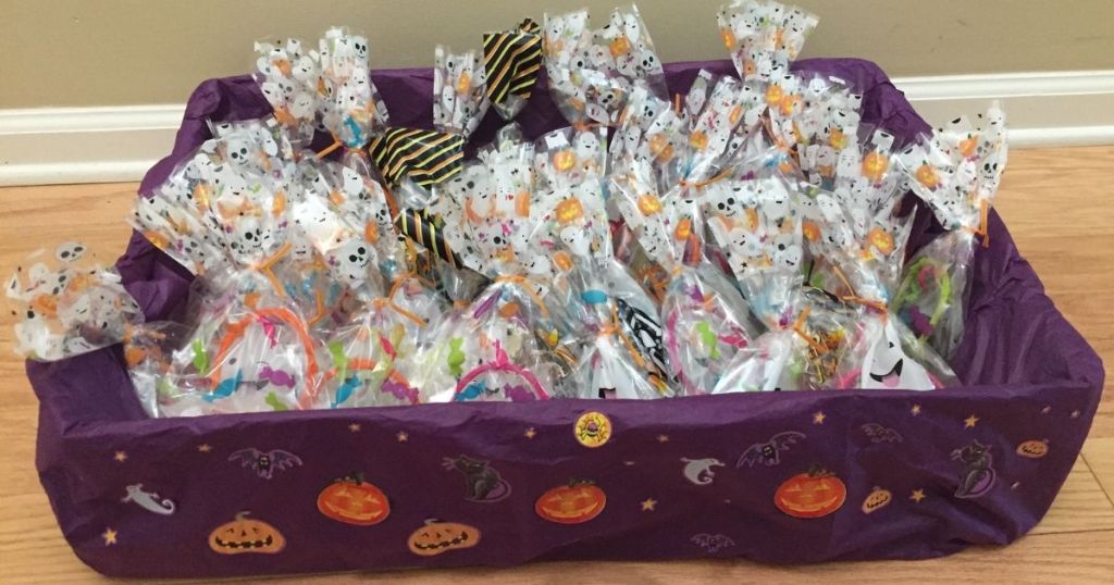 box covered with purple tissue paper, Halloween stickers and filled with festive goodie bags