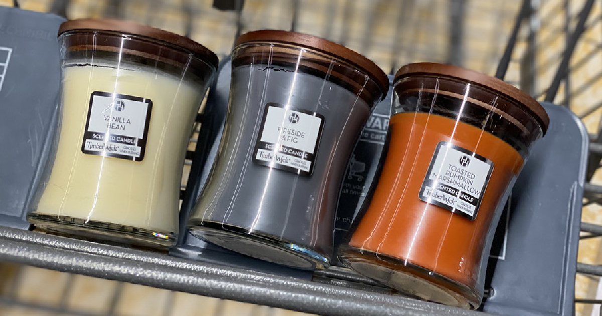 three different scented candles in store cart