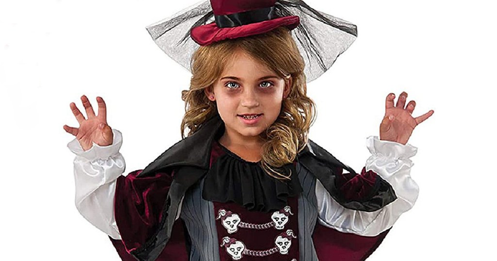 Little girls wearing scary makeup and a fancy vampire halloween costume