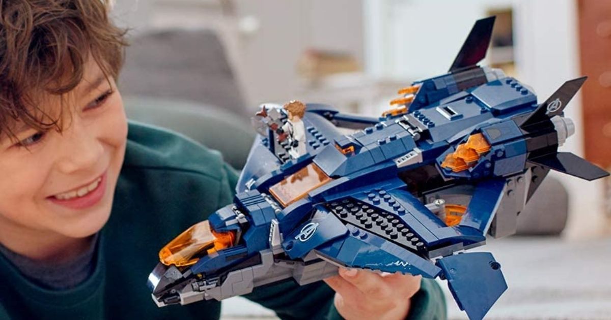 boy playing with LEGO jet set