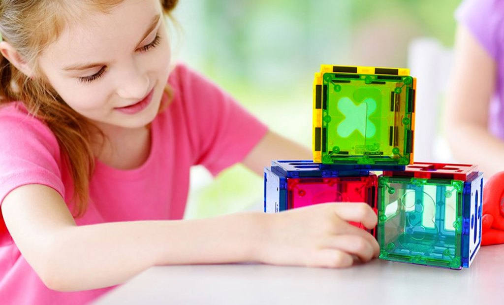 girl playing with magnetic numerical building block set