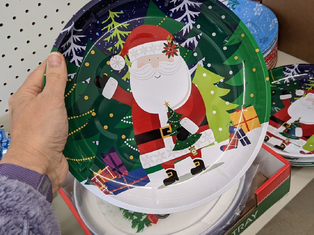 hand holding plate with Santa on it