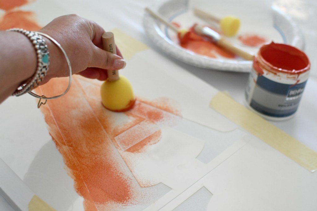 Using a dabber to stencil a fall porch sign