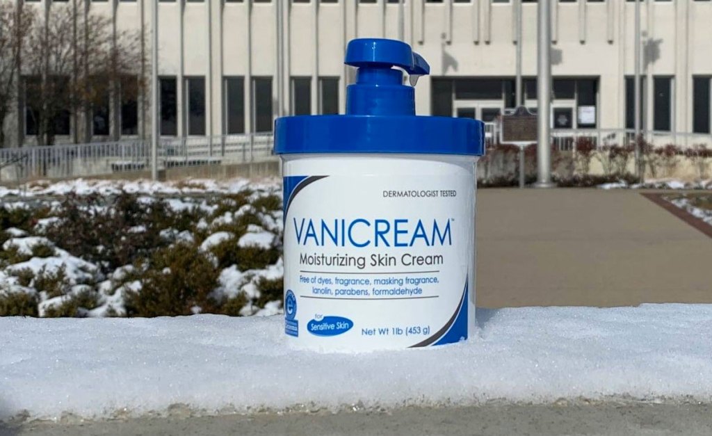 white and blue jar of vanicream moisturizer on snowy bench outside