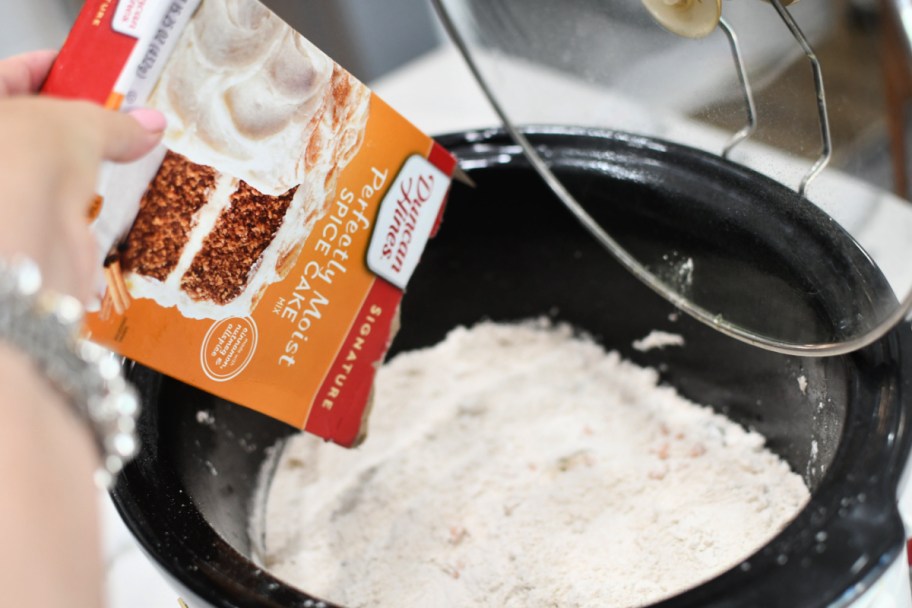 adding cake mix to slow cooker to make a dump cake 