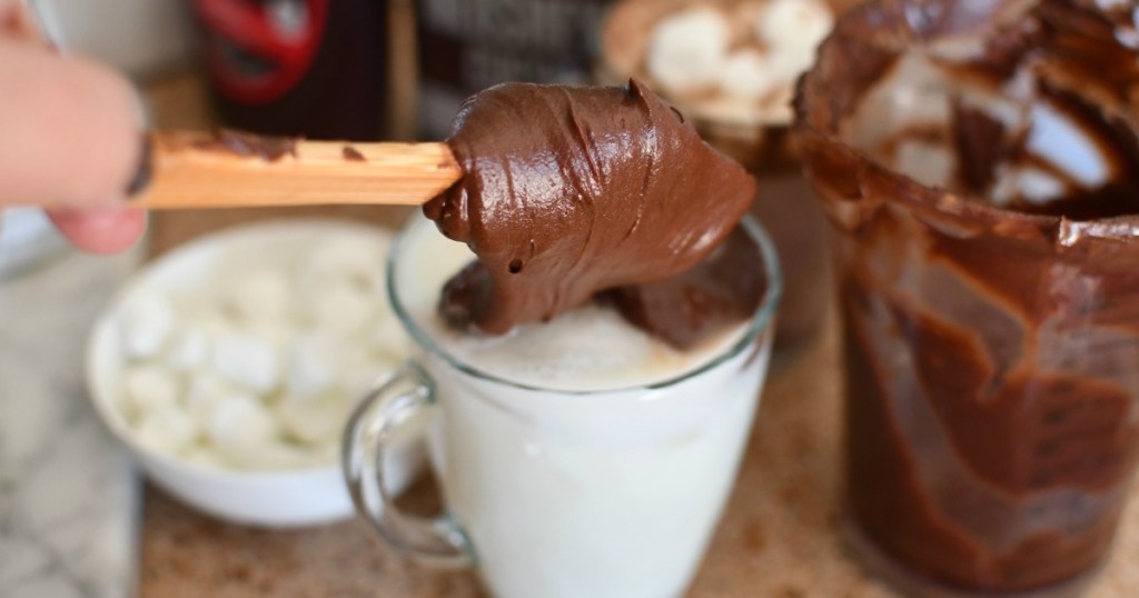 adding whipped chocolate to mug