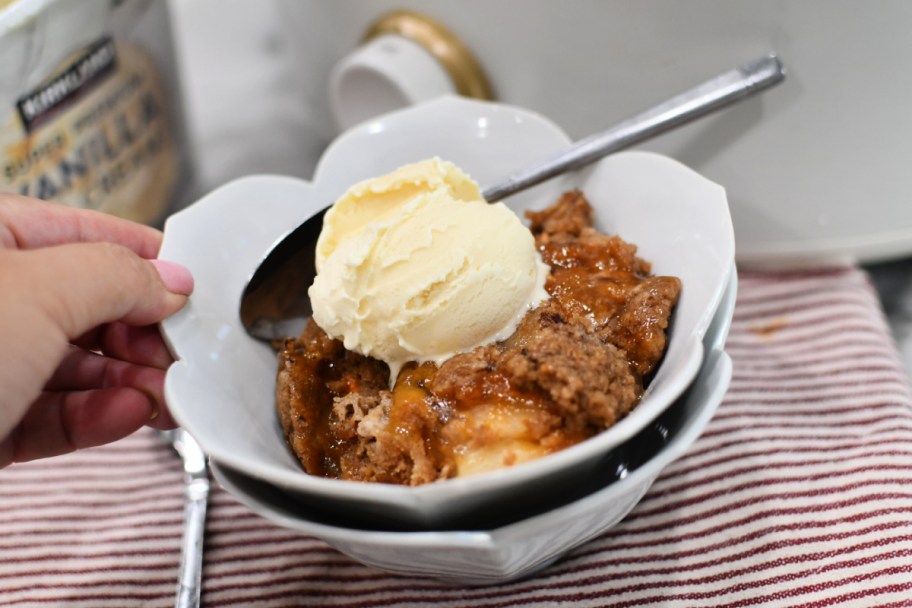 bowl with warm appl dump cake and vanilla ice cream 