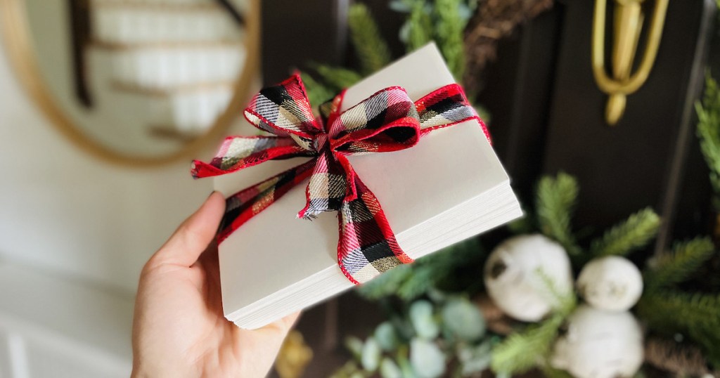 hand holding wrapped stack of cards