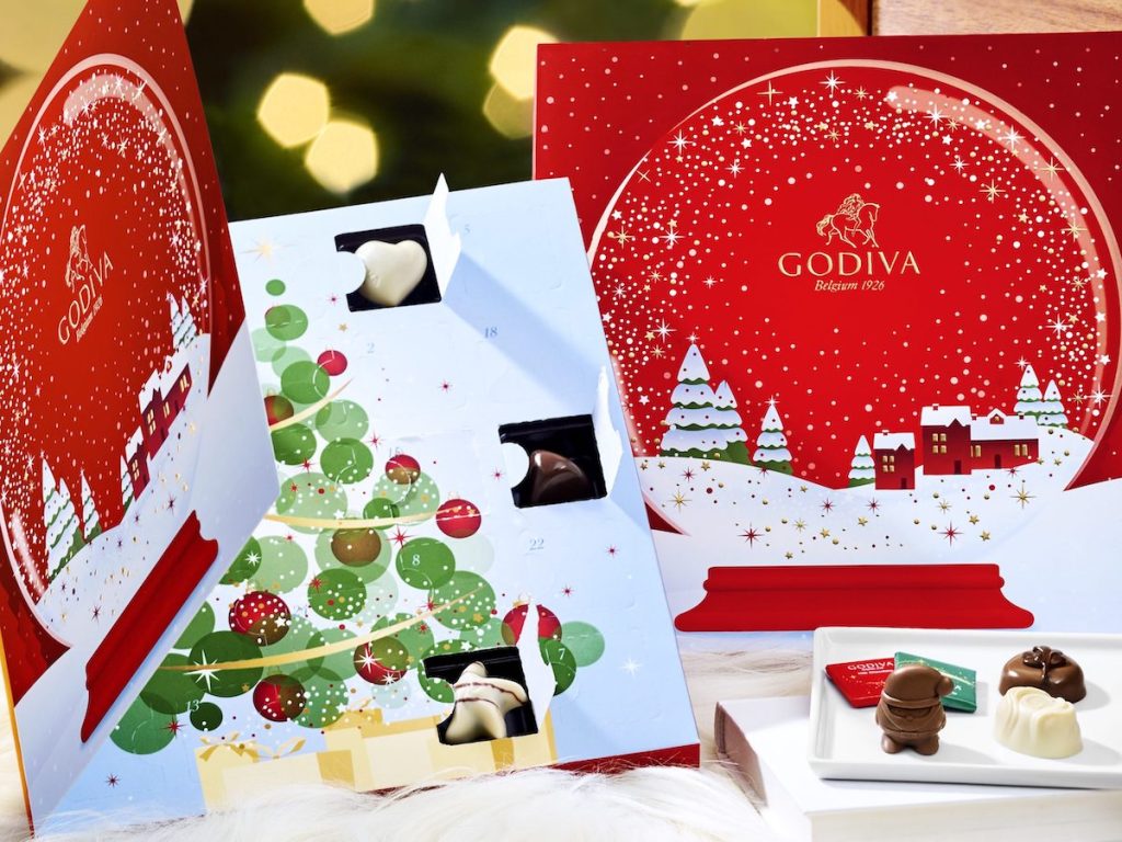 two godiva advent calendars with chocolate truffles on white plate