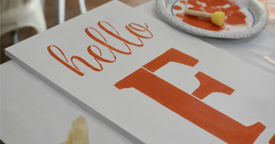 stencilling hello on a fall sign