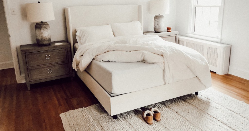 white bedding with sheets taken off corner of zinus mattress