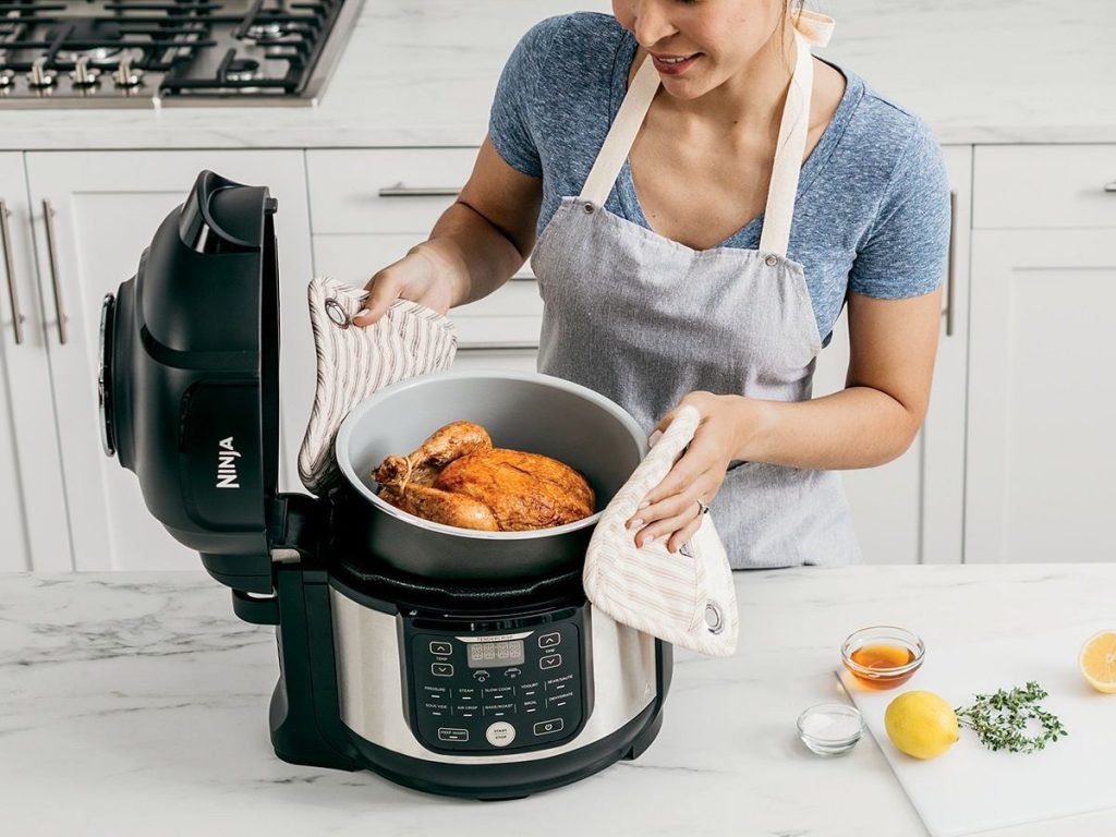 woman cooking wtih ninja 11-in-1 pro foodi